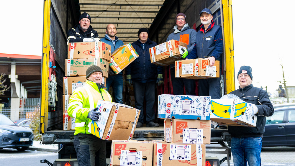 Mit vereinten Kräften: Gemeinsam haben freiwillige Helfer aus dem Bischöflichen Generalvikariat mit dem Koordinator des Auslandsdienstes der Malteser Fulda, Alfred Hau, und den LKW-Fahrern den Winter-Hilfstransport für die Ukraine beladen.