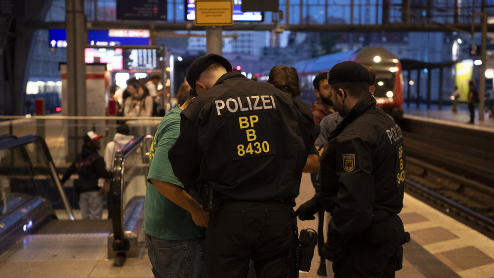 Bundespolizisten überprüfen auf einem Berliner Bahnhof einen Mann